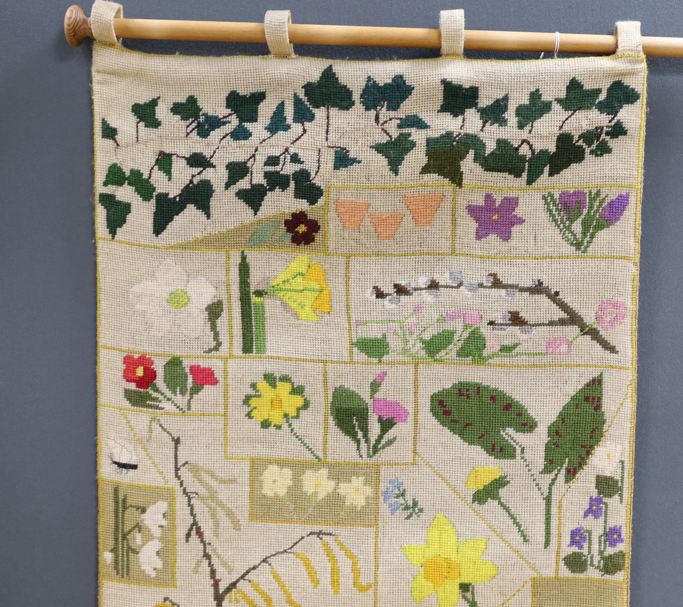 A cross-stitch wall hanging of wildflowers, 140cm high